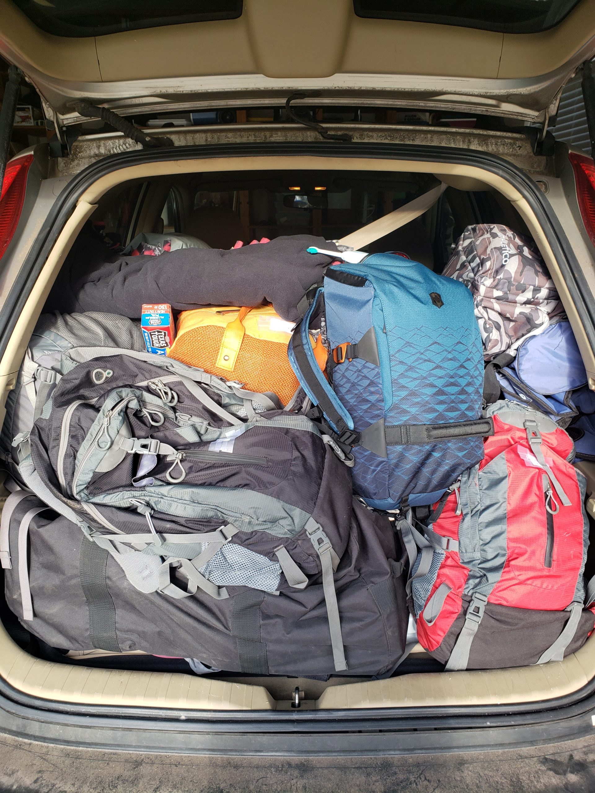 Back of an SUV loaded with bags